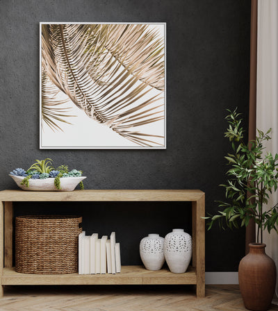 Kentia Palm View artwork on canvas in a white float frame on a dark wall above a wooden console table 