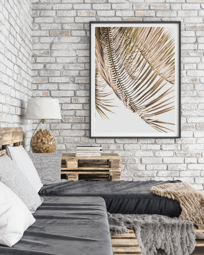 Cozy living room with a gray sofa and a framed Kentia Palm View print on a brick wall | ARRTOPIA