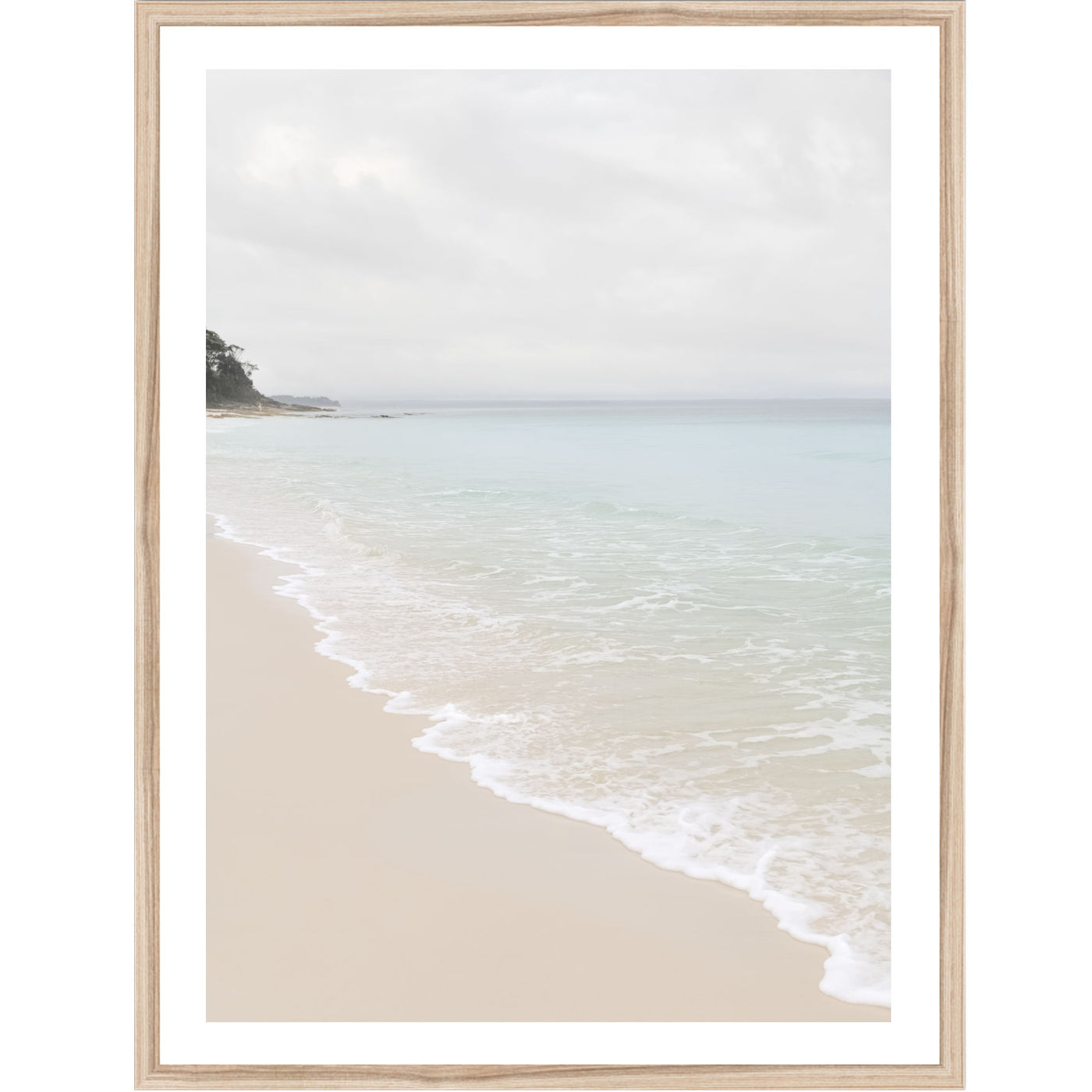 Framed photographic artwork of a beach scene with calm ocean waves and beige sand.