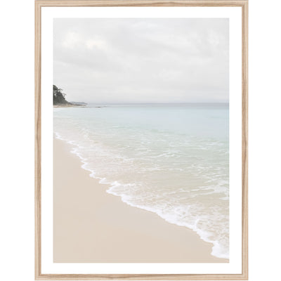 Framed photographic artwork of a beach scene with calm ocean waves and beige sand.