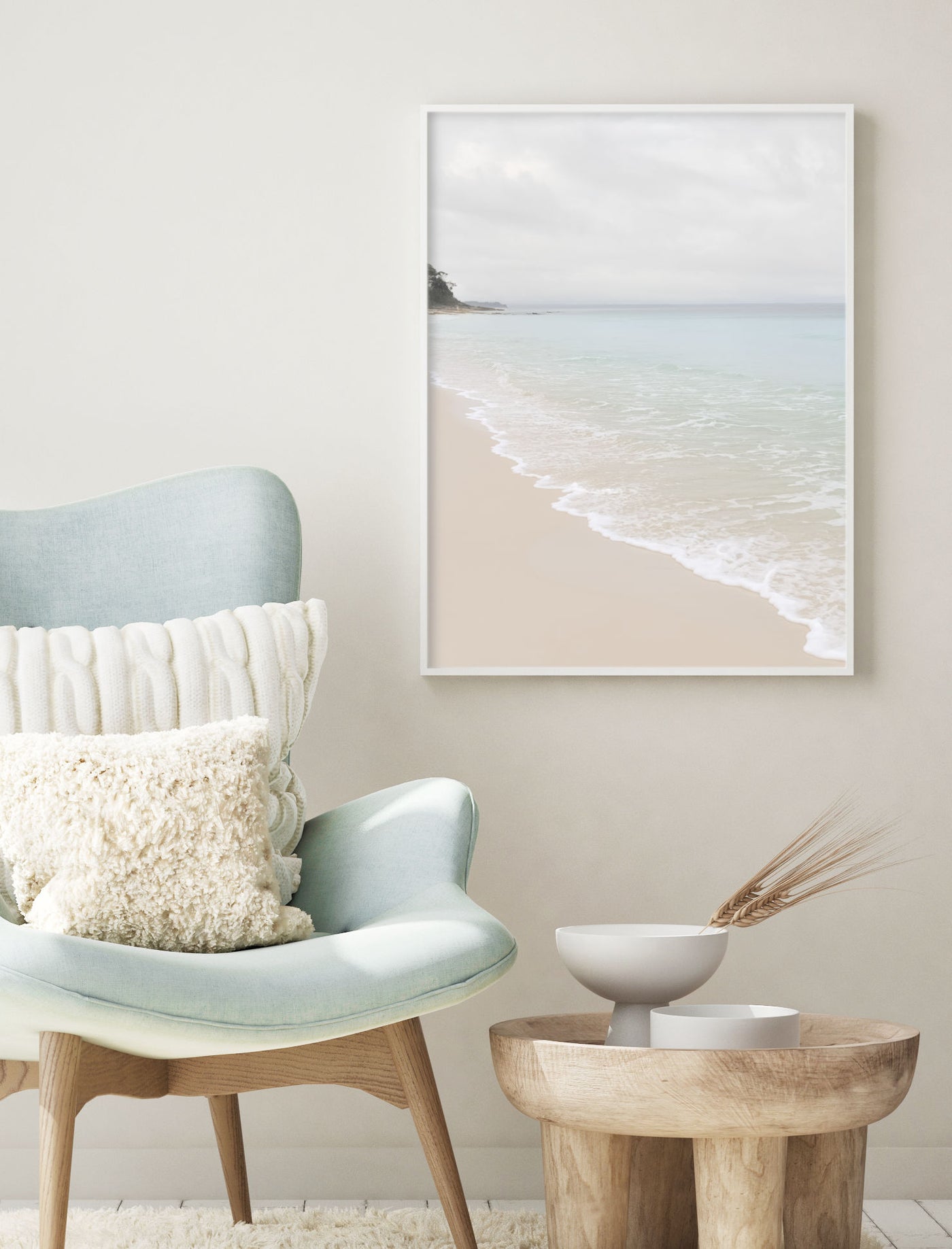 Greenfield Beach artwork in a modern interior with a light blue chair and wooden side table