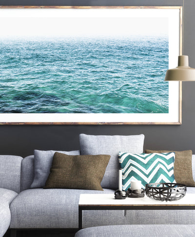colorful oversized ocean wall art print by arrtopia in contemporary living room over sofa